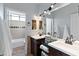 Bright bathroom features a double sink vanity with sleek fixtures and a separate tub/shower at 1835 E Bartlett Pl, Chandler, AZ 85249