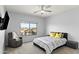 Bedroom with a ceiling fan, large window, and a chair at 1835 E Bartlett Pl, Chandler, AZ 85249