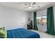 Cozy bedroom with a desk, window, and a ceiling fan at 1835 E Bartlett Pl, Chandler, AZ 85249