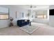 Comfortable living room area with a large window, sleek furniture, and bright decor at 1835 E Bartlett Pl, Chandler, AZ 85249