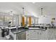 Open concept kitchen with stainless steel appliances, granite countertops, and view to the dining and living rooms at 1835 E Bartlett Pl, Chandler, AZ 85249