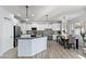 Modern kitchen with white cabinets, stainless steel appliances, and an island with bar seating at 1835 E Bartlett Pl, Chandler, AZ 85249