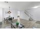 Spacious living room with wood-look tile, open staircase, and comfortable seating arrangement at 1835 E Bartlett Pl, Chandler, AZ 85249