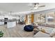 Open living area with a spacious sectional, adjoining kitchen, and dining space with bright natural light at 1835 E Bartlett Pl, Chandler, AZ 85249