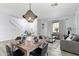 Open-concept living space featuring a dining table, cozy seating area, and light wood floors at 1835 E Bartlett Pl, Chandler, AZ 85249