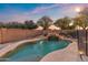 Sparkling pool with rock waterfall, offering a private backyard oasis for relaxation at 1835 E Bartlett Pl, Chandler, AZ 85249
