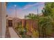 Cozy side yard featuring garden bed, brick wall, and a wooden gate at 1835 E Bartlett Pl, Chandler, AZ 85249