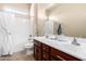 Bright bathroom featuring dual vanity sinks, bath tub, and neutral decor at 18406 W Verbena Dr, Goodyear, AZ 85338
