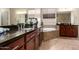 Elegant bathroom with dual sinks, granite counters, and a luxurious soaking tub at 18406 W Verbena Dr, Goodyear, AZ 85338