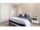 Comfortable bedroom with carpet, white trim, and blue bedding at 18406 W Verbena Dr, Goodyear, AZ 85338
