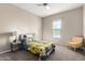 Cozy bedroom with neutral tones, ceiling fan, and a comfortable sitting area at 18406 W Verbena Dr, Goodyear, AZ 85338