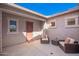 Private courtyard with cushioned seating, neutral color scheme, and a welcoming entrance at 18406 W Verbena Dr, Goodyear, AZ 85338