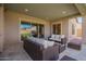 This covered patio features outdoor seating and access to the home's backyard at 18406 W Verbena Dr, Goodyear, AZ 85338