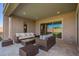 A covered patio with outdoor seating and a view of the backyard at 18406 W Verbena Dr, Goodyear, AZ 85338
