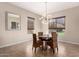 Cozy dining area with rattan chairs, a modern chandelier, and natural light at 18406 W Verbena Dr, Goodyear, AZ 85338
