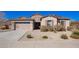 Charming single-Gathering home featuring a stone facade, a two-car garage, and drought-tolerant landscaping at 18406 W Verbena Dr, Goodyear, AZ 85338