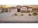 Charming single-story home with desert landscaping, neutral stucco, and a two-car garage at 18406 W Verbena Dr, Goodyear, AZ 85338