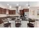 Beautiful kitchen island with barstool seating, sleek granite counters, and stainless steel appliances at 18406 W Verbena Dr, Goodyear, AZ 85338