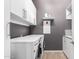 This laundry room has a white washer and dryer and white cabinets at 18406 W Verbena Dr, Goodyear, AZ 85338