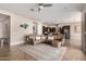 Inviting open floor plan with a sectional couch, tile flooring, and kitchen access at 18406 W Verbena Dr, Goodyear, AZ 85338