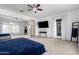 Large primary bedroom featuring a ceiling fan, ample space, and a sliding glass door to the outside at 18406 W Verbena Dr, Goodyear, AZ 85338