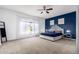 Spacious primary bedroom with a statement accent wall and soft natural light at 18406 W Verbena Dr, Goodyear, AZ 85338