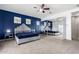 Luxurious primary bedroom featuring a mirrored closet, ceiling fan, and vibrant accent wall at 18406 W Verbena Dr, Goodyear, AZ 85338