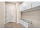 Well-organized mudroom with built-in storage, cabinets, and a convenient bench at 18406 W Verbena Dr, Goodyear, AZ 85338