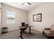 Comfortable home office with natural light, a modern desk, and cozy seating at 18406 W Verbena Dr, Goodyear, AZ 85338