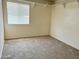 Bright bedroom featuring beige walls, a window, and carpet flooring at 1859 E 8Th St, Mesa, AZ 85203