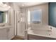 Bathroom featuring a glass shower, soaking tub, and modern fixtures at 1941 W Trotter Trl, Phoenix, AZ 85085