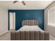 Bedroom featuring a blue accent wall, plush carpet, and bright natural light at 1941 W Trotter Trl, Phoenix, AZ 85085