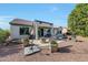 Comfortable covered patio with a lounge area, dining set, a fire pit, and desert landscaping at 20049 N Siesta Rock Dr, Surprise, AZ 85374