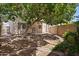 Spacious backyard with mature tree providing ample shade and desert landscaping at 2051 W Ronald Rd, Phoenix, AZ 85029