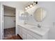 Bathroom boasting a double vanity, framed mirrors, and an open door to the walk-in closet at 2051 W Ronald Rd, Phoenix, AZ 85029
