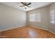 Bright bedroom with wood floors, ceiling fan, and large windows at 2051 W Ronald Rd, Phoenix, AZ 85029