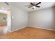 Well-lit room with wood floors and ceiling fan at 2051 W Ronald Rd, Phoenix, AZ 85029