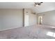 Spacious room featuring neutral walls, carpet, and high ceiling with ceiling fan at 2051 W Ronald Rd, Phoenix, AZ 85029