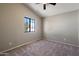Clean, empty bedroom with natural light from large window, carpeted floor and vaulted ceiling at 2051 W Ronald Rd, Phoenix, AZ 85029