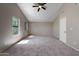 Spacious carpeted bedroom with vaulted ceilings, two windows, and a neutral color scheme at 2051 W Ronald Rd, Phoenix, AZ 85029