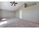 Bright and spacious room with high ceiling, neutral walls, carpet and fan at 2051 W Ronald Rd, Phoenix, AZ 85029