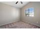 Minimalist bedroom design with large window allowing natural light and carpeted floor at 2051 W Ronald Rd, Phoenix, AZ 85029