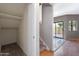 Hallway featuring a small storage room with carpet flooring and convenient access to the backyard at 2051 W Ronald Rd, Phoenix, AZ 85029