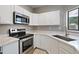 Modern kitchen with stainless steel appliances and bright counter space at 2051 W Ronald Rd, Phoenix, AZ 85029