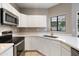 Updated kitchen featuring stainless steel microwave and oven complemented by plentiful cabinet space at 2051 W Ronald Rd, Phoenix, AZ 85029