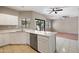 Open kitchen and living room area featuring stainless steel dishwasher and large island at 2051 W Ronald Rd, Phoenix, AZ 85029