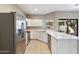 Open kitchen with stainless steel appliances, abundant counter space, and views to the backyard at 2051 W Ronald Rd, Phoenix, AZ 85029