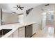 Bright kitchen island with dishwasher and views to the living room and staircase at 2051 W Ronald Rd, Phoenix, AZ 85029
