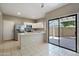 Spacious kitchen with stainless steel appliances and sliding glass door to the backyard at 2051 W Ronald Rd, Phoenix, AZ 85029