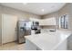 Well-lit kitchen with stainless steel refrigerator, updated appliances, and bright countertop at 2051 W Ronald Rd, Phoenix, AZ 85029